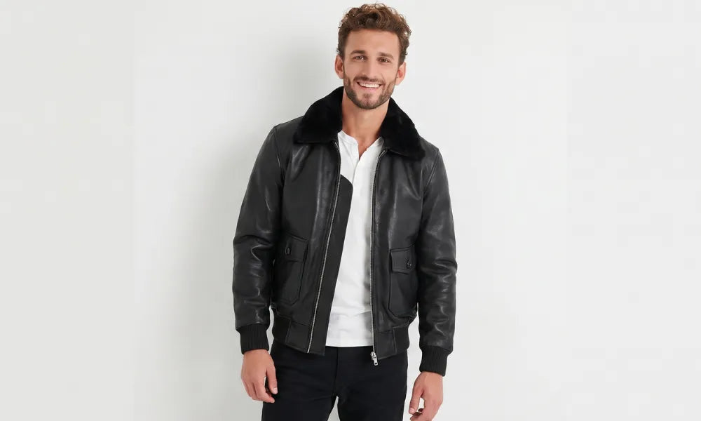 Men's leather bomber jacket with a black shearling collar, front view on a model