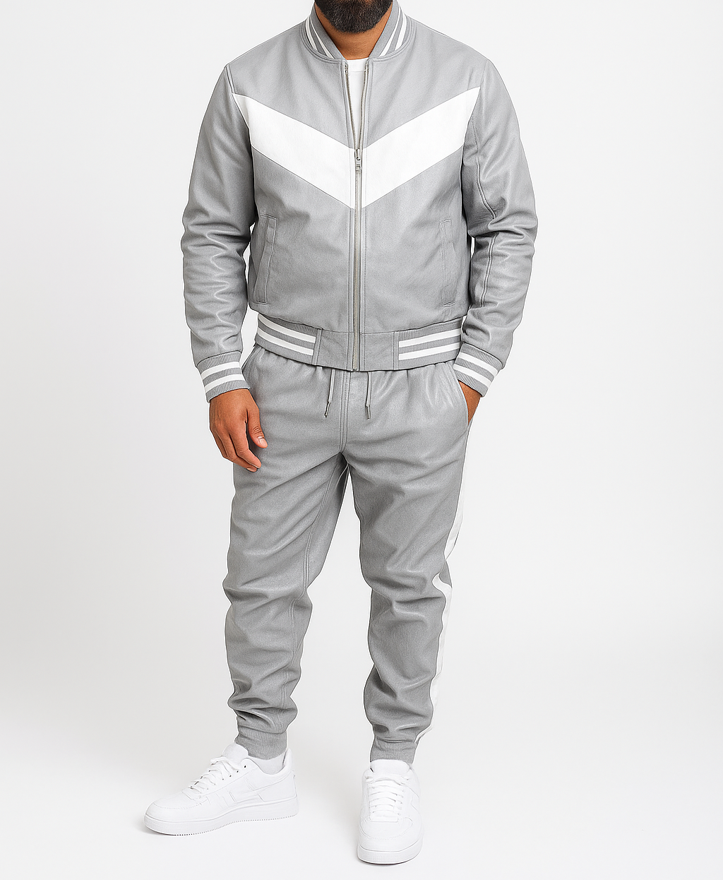 Gray tracksuit with white accents worn by a person on a white background