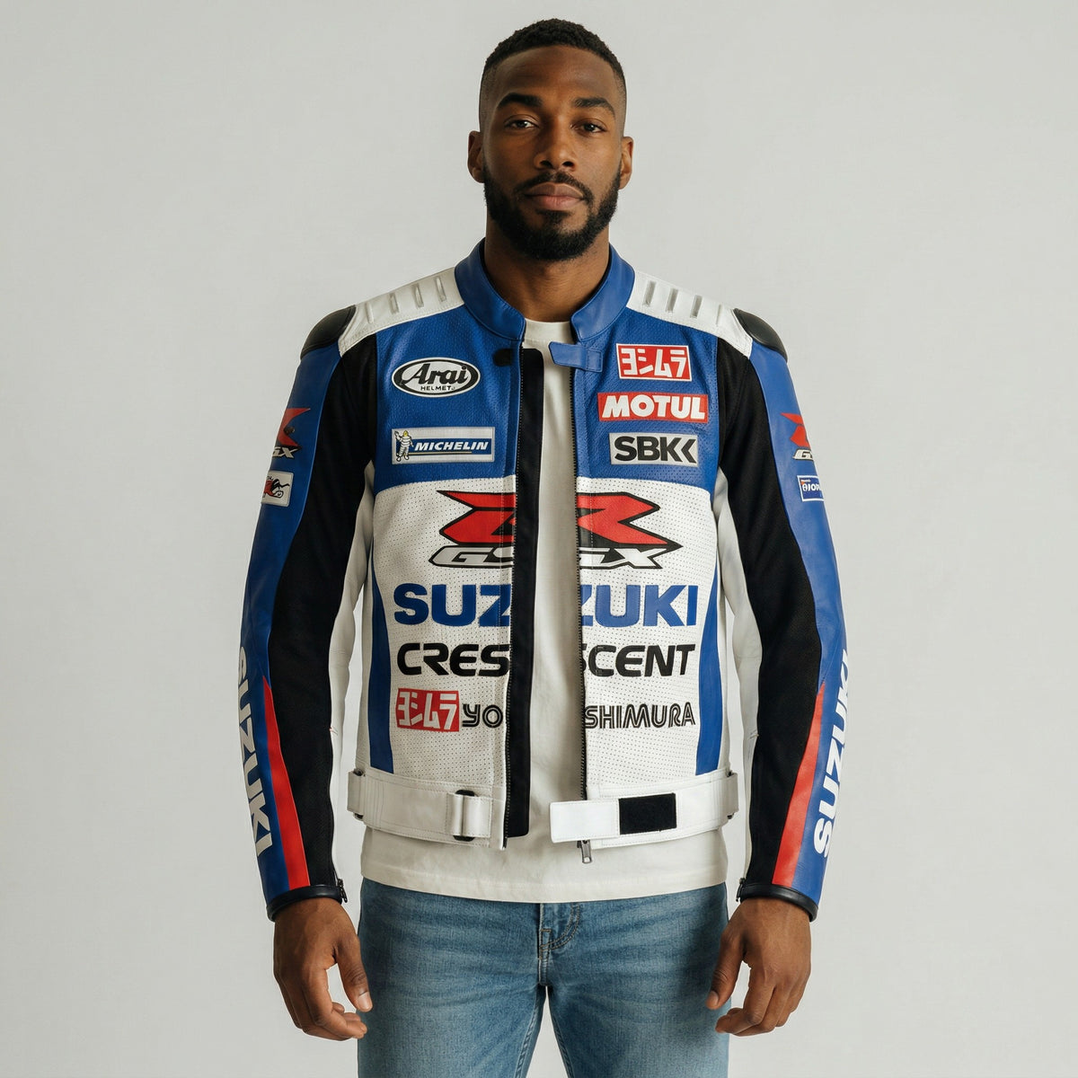 Person wearing a branded Suzuki GSX-R motorcycle jacket with various logos on a gray background