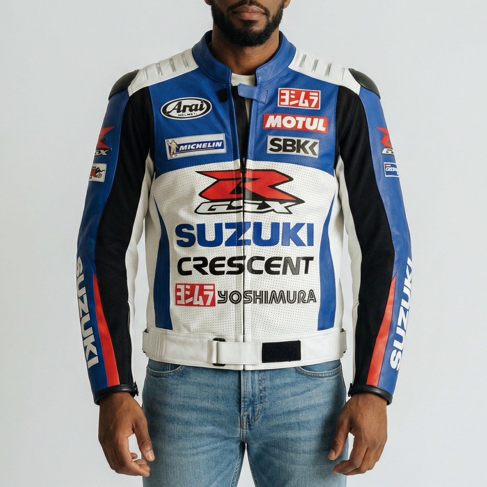Man wearing a branded suzuki GSX-R motorcycle jacket with various logos on a plain background