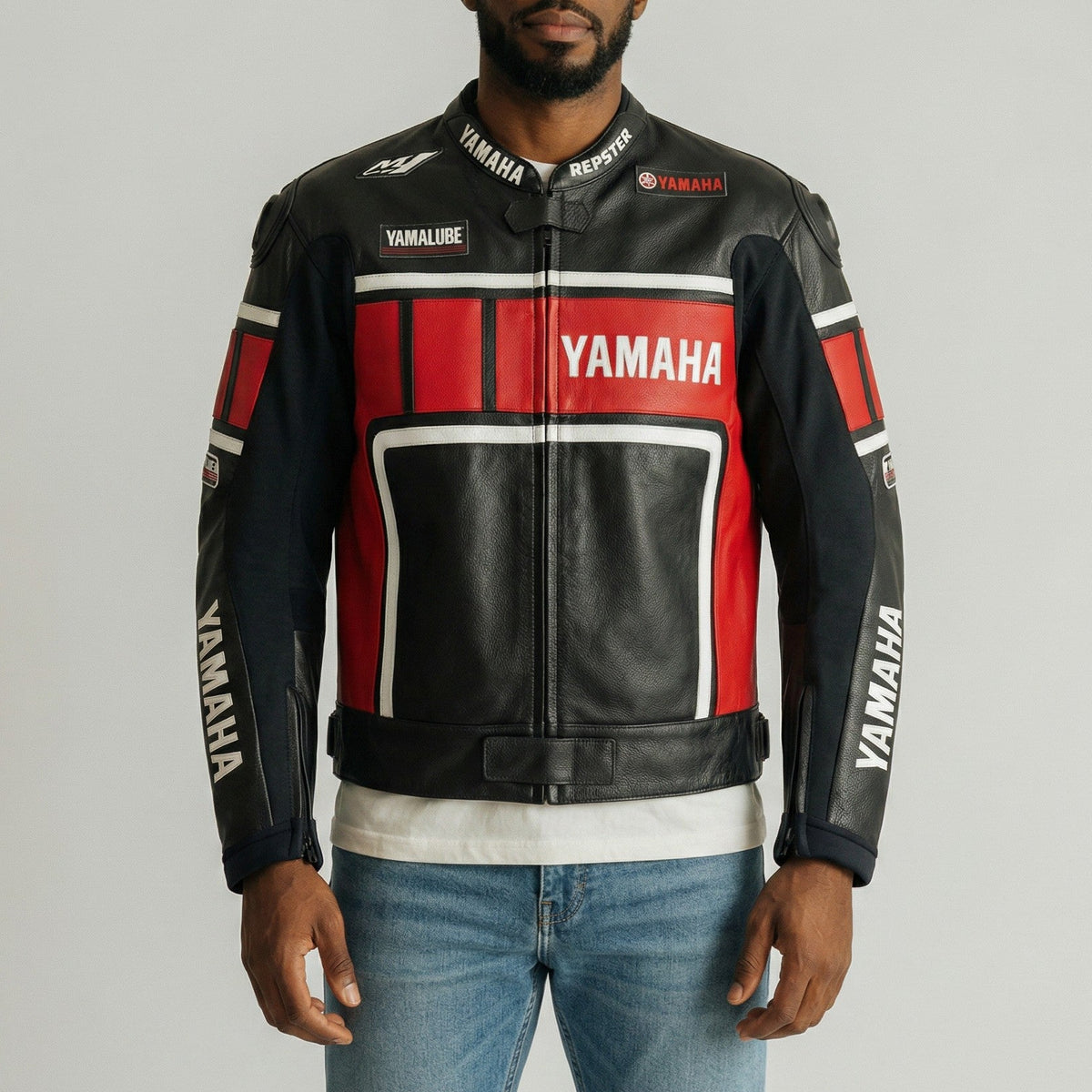 Man wearing a Yamaha leather jacket on a gray background