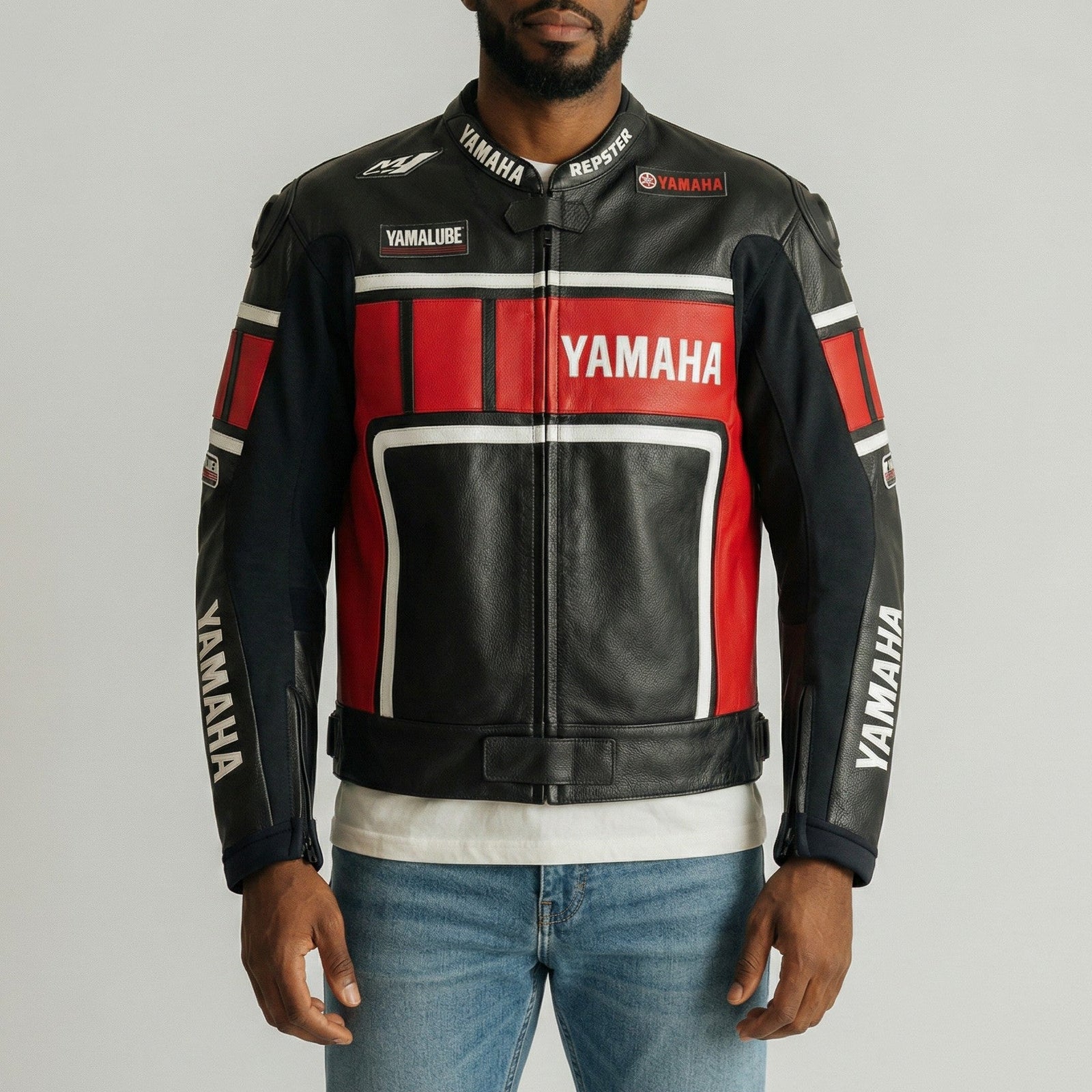 Man wearing a Yamaha leather jacket on a gray background