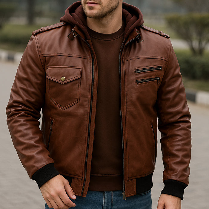 Man wearing a brown leather jacket with a hood outdoors