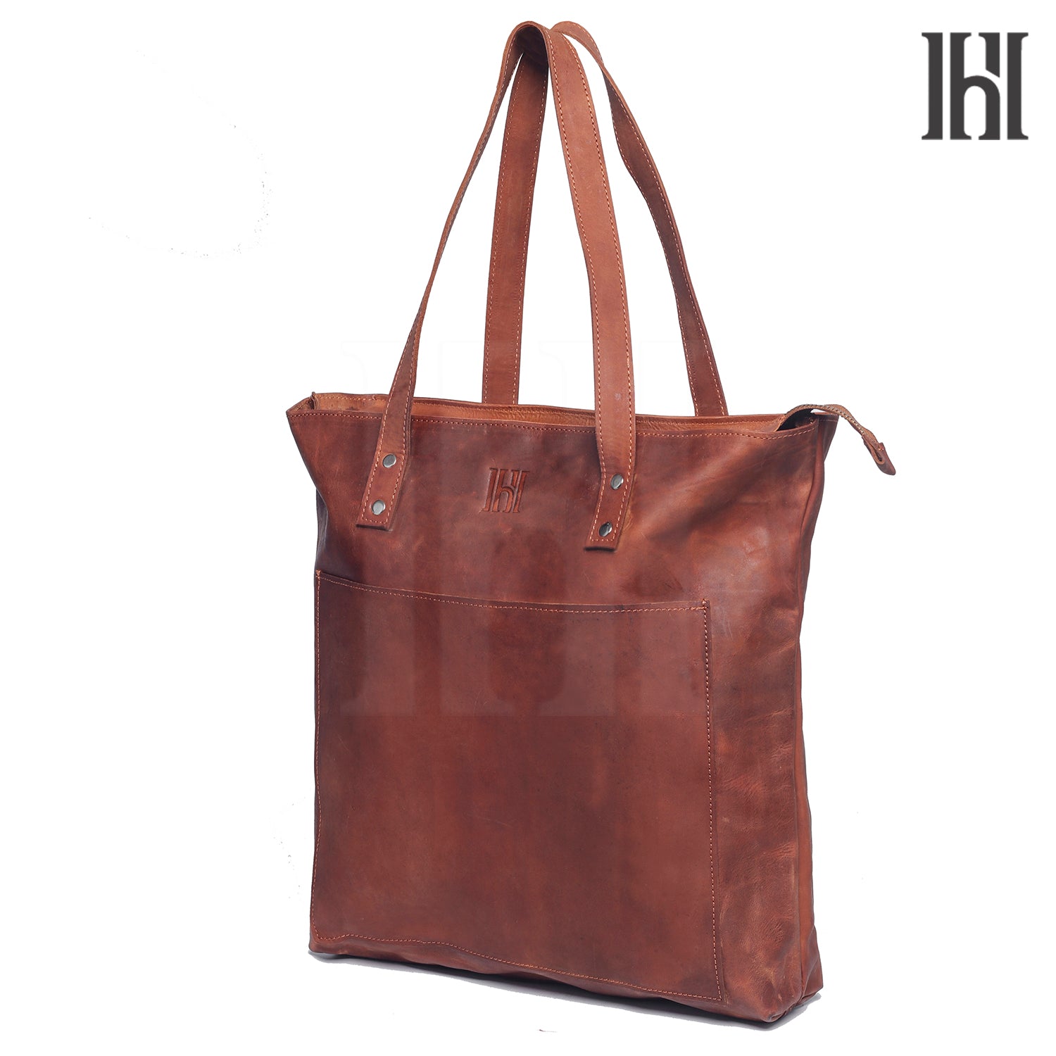 A brown leather tote bag with two handles and a branded label on the bottom right.