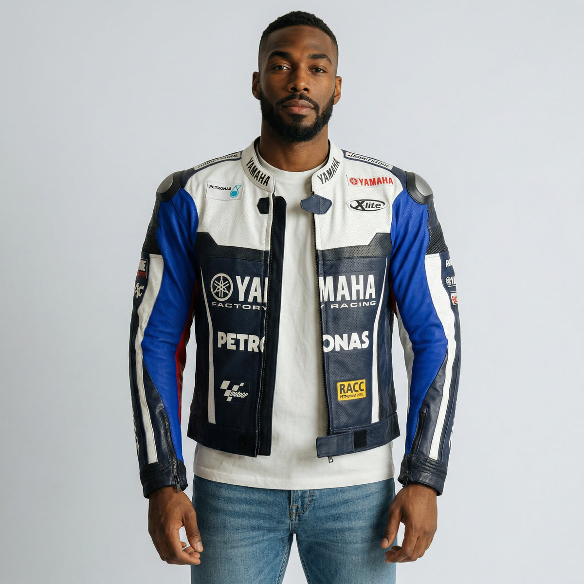 Man wearing a Yamaha Petronas racing jacket on a plain background