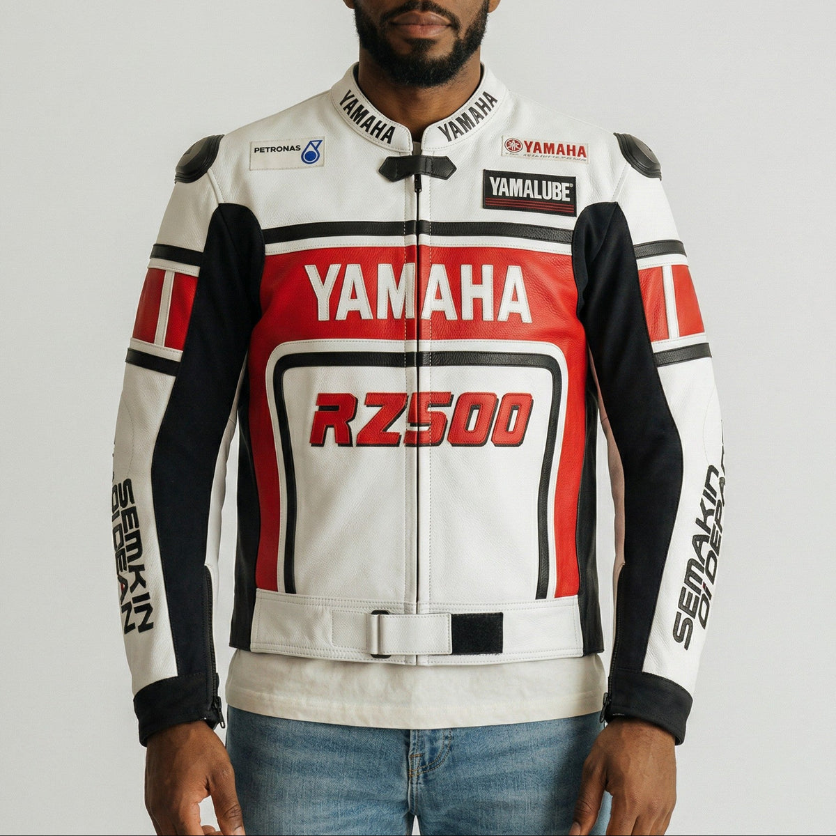 Man wearing a Yamaha rz500 motorcycle jacket on a plain background