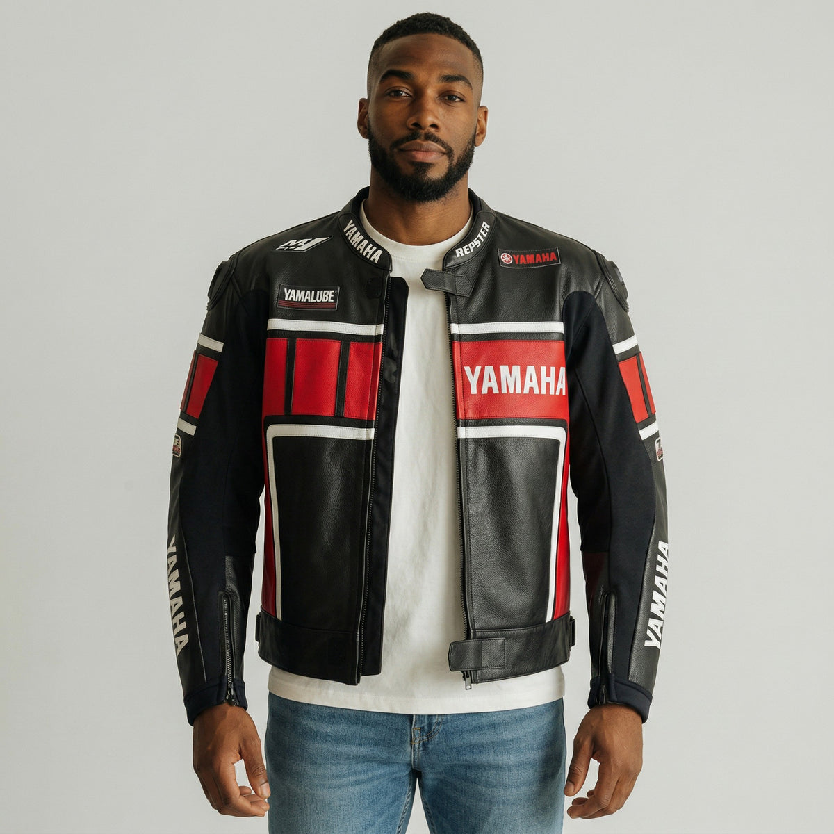 Man wearing a Yamaha branded leather jacket on a gray background