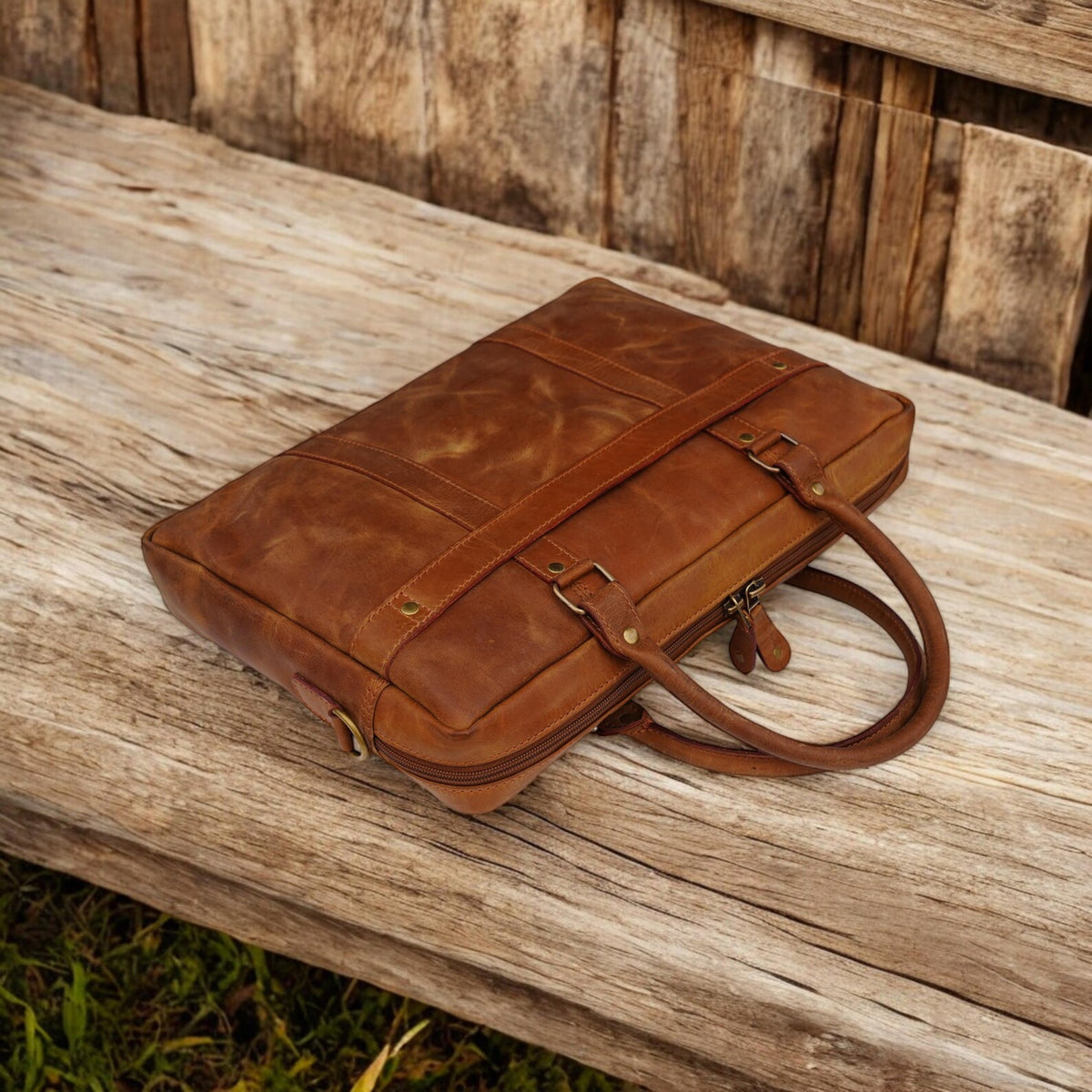 Brown leather laptop slim bag on a wooden surface
