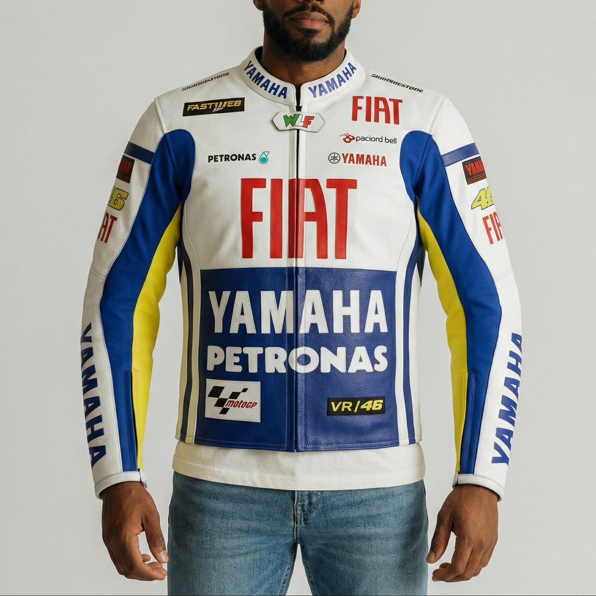 Man wearing a Yamaha, Fiat, and Petronas branded jacket on a gray background