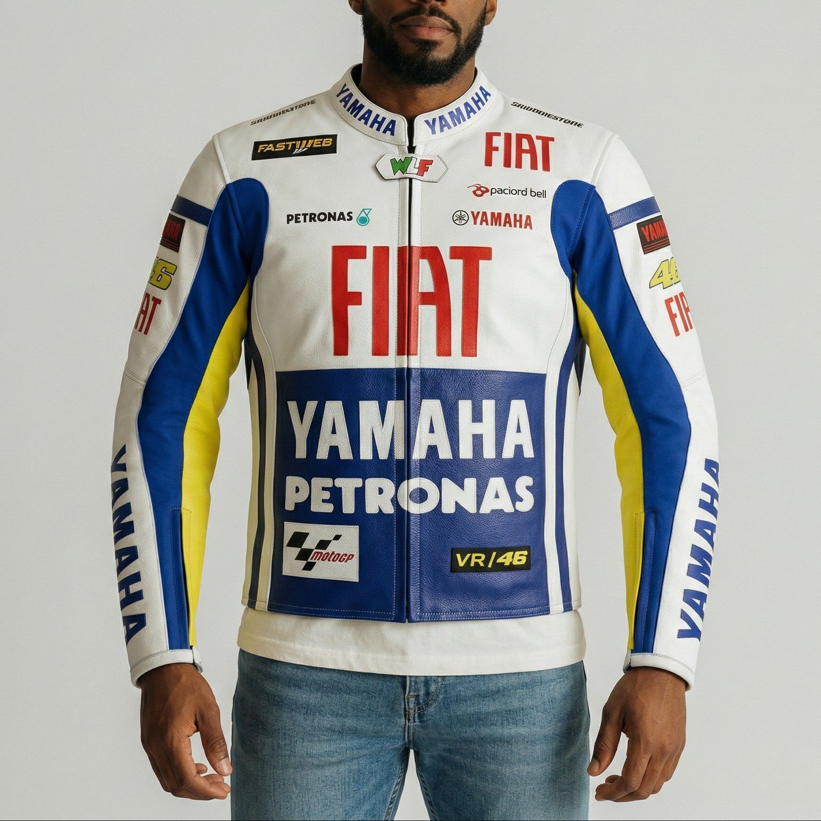Man wearing a Yamaha, Fiat, and Petronas branded jacket on a gray background